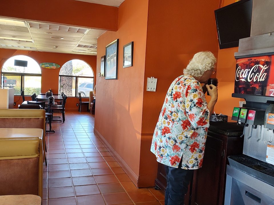 Simple restaurant interior with seating and menu boards.